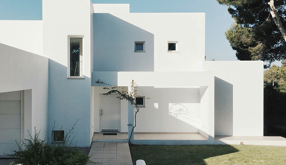 A house painted wall white and lawn