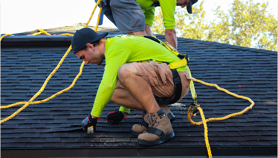 Two professionals working to repair the roof of a house