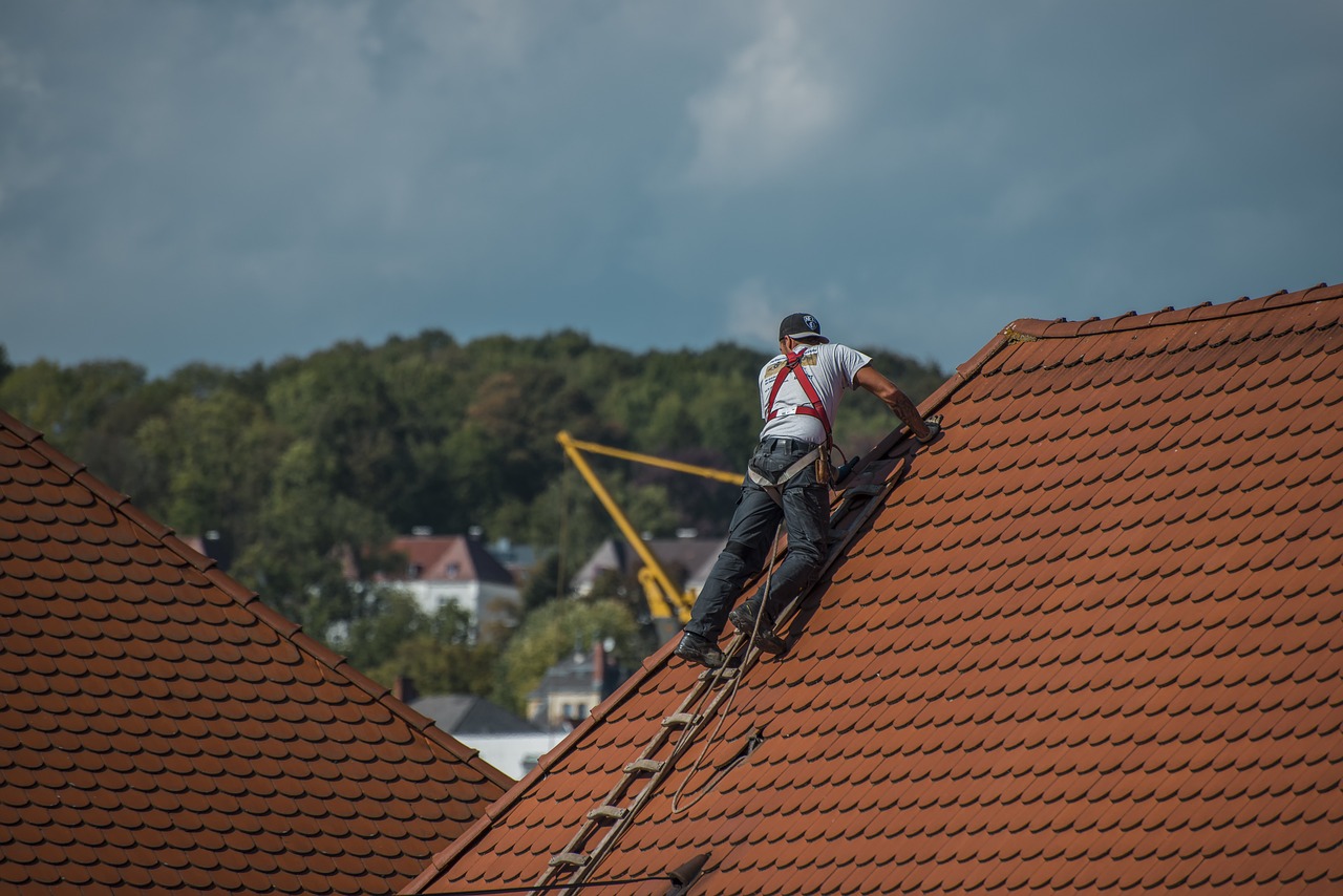 A contractor fixing the roof of the House