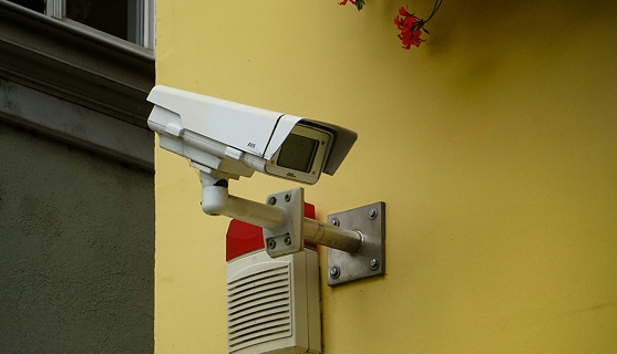 CCTV Camera mounted a yellow colored wall